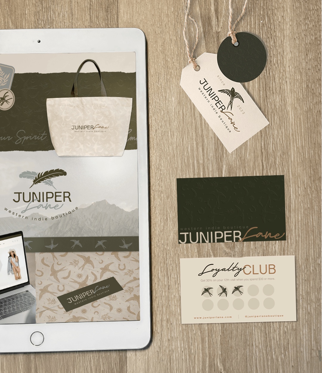 Brand identity mockup on an iPad, printed front and back loyalty cards, and custom clothing tags displayed on a wooden table.